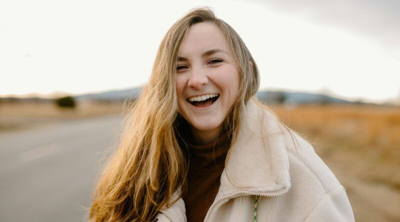 smiling woman in green jacket